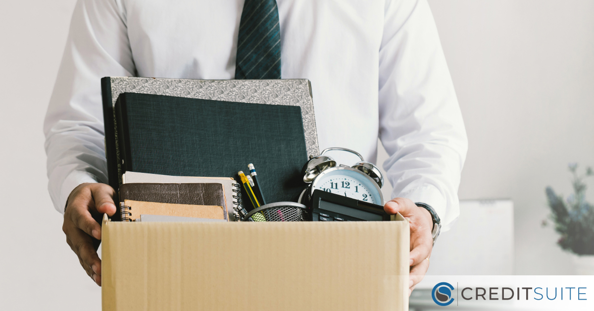 The Great Resignation Credit Suite - A man carrying a box with personal office items.