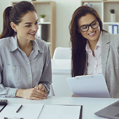 sba loan options credit suite 7 two women looking at paperwork smiling