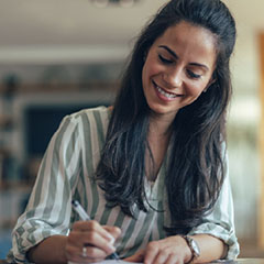 sba loan options credit suite 4 woman smiling and writing